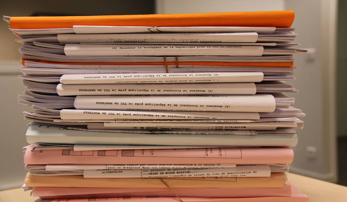 Stack of silo'd information in the form of paper.